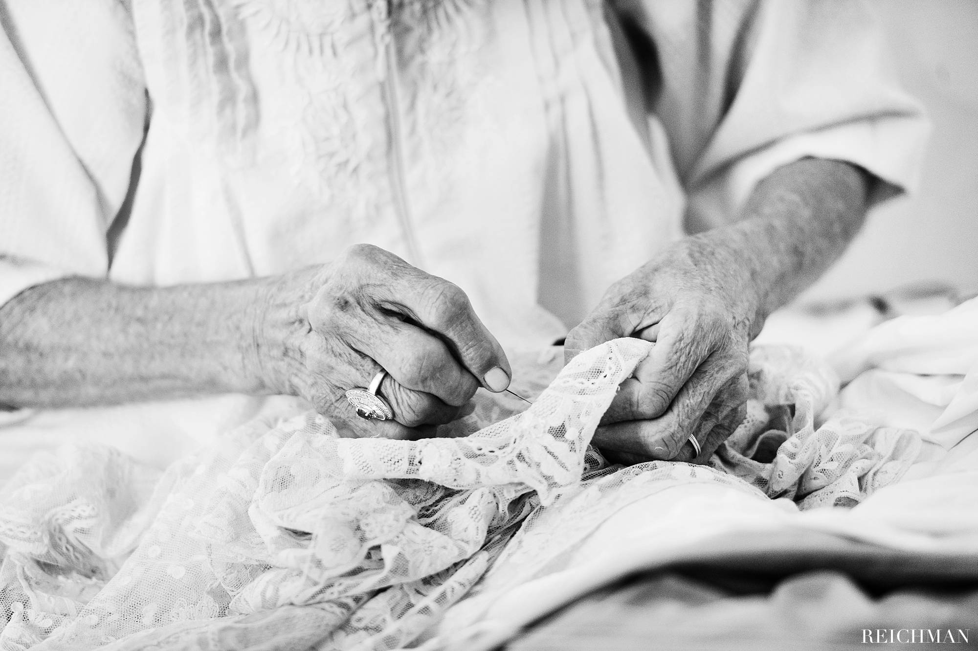brides grandmother sewing veil